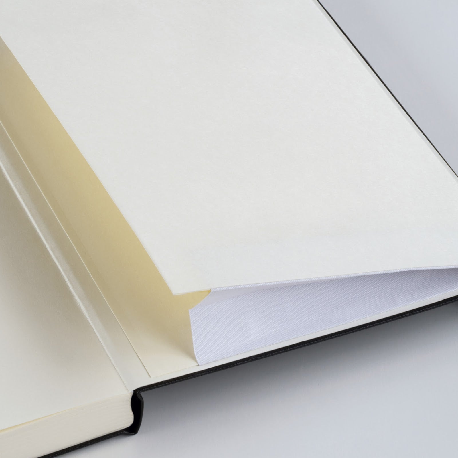 Close-up of notebook inside cover envelope on a light gray background