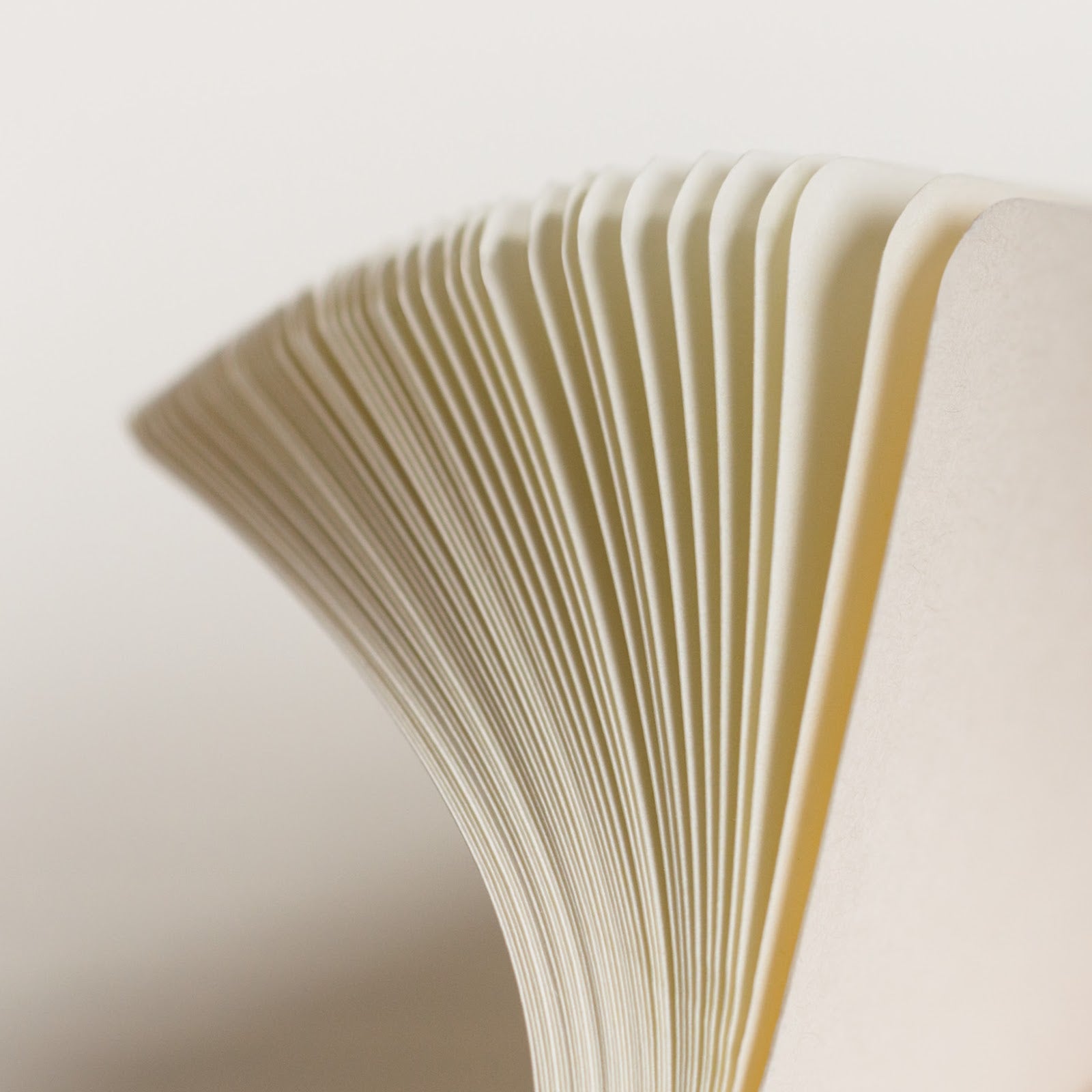 Close-up of flipping through notebook pages with a soft focus background