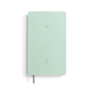Mint green notebook with '2027' printed on a white background