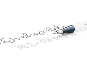 A close-up of a white and dark gray ballpoint pen writing cursive text on a clean white surface.
