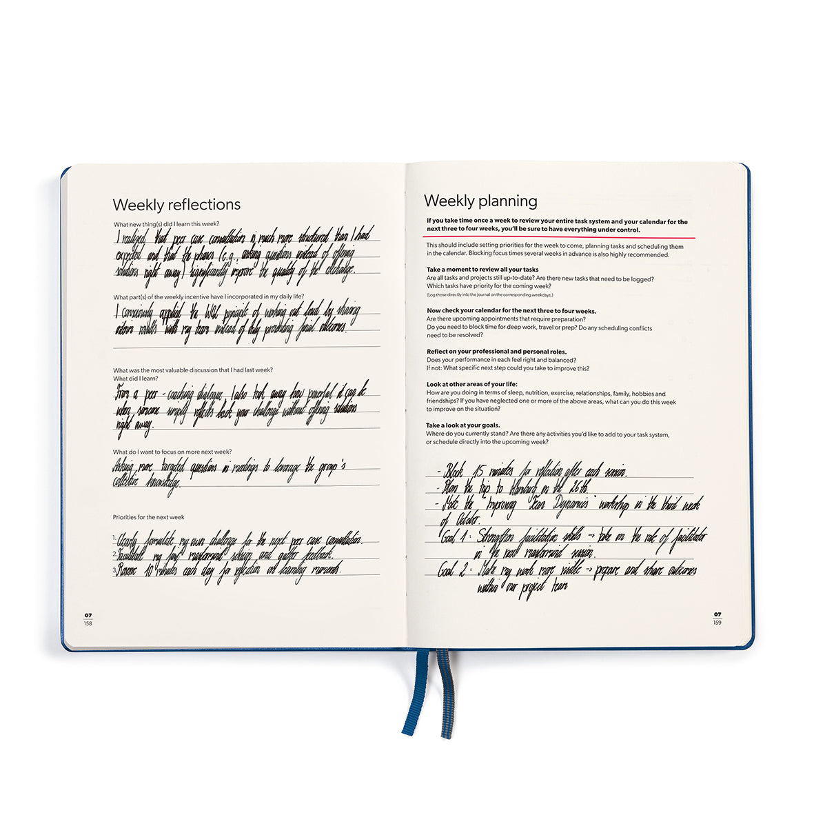 Open notebook with handwritten weekly reflections and planning on cream pages.