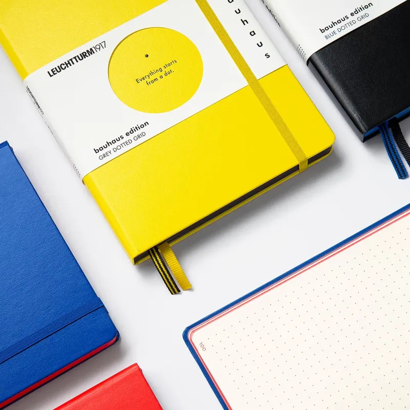 Colorful notebooks with visible brand names on a white background