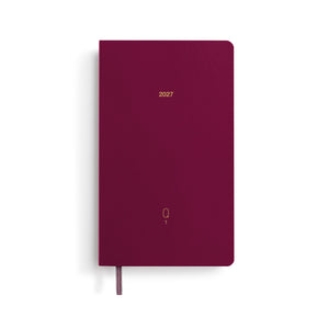 Maroon notebook with '2027' printed on it against a white background
