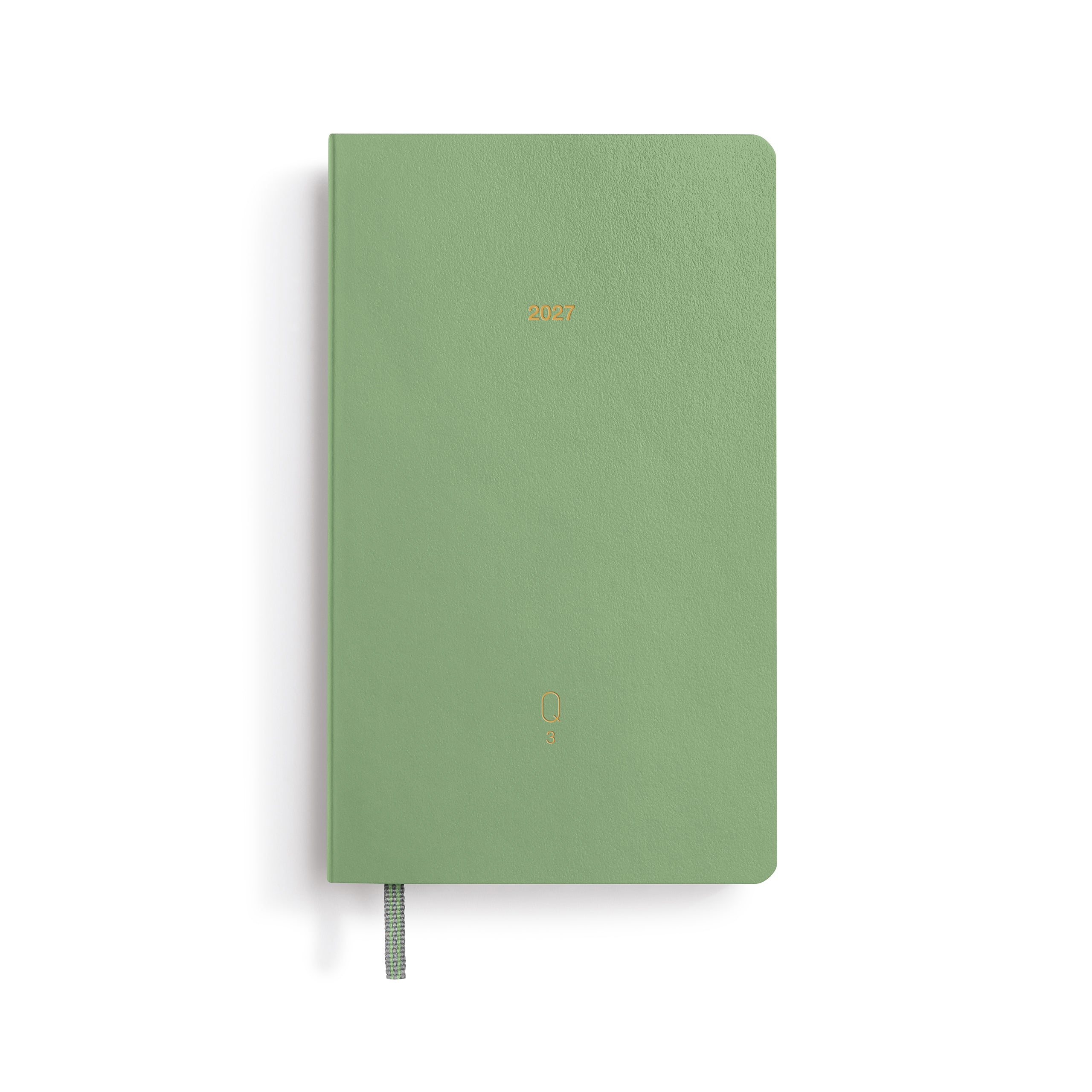 Green notebook with a gold logo on a white background