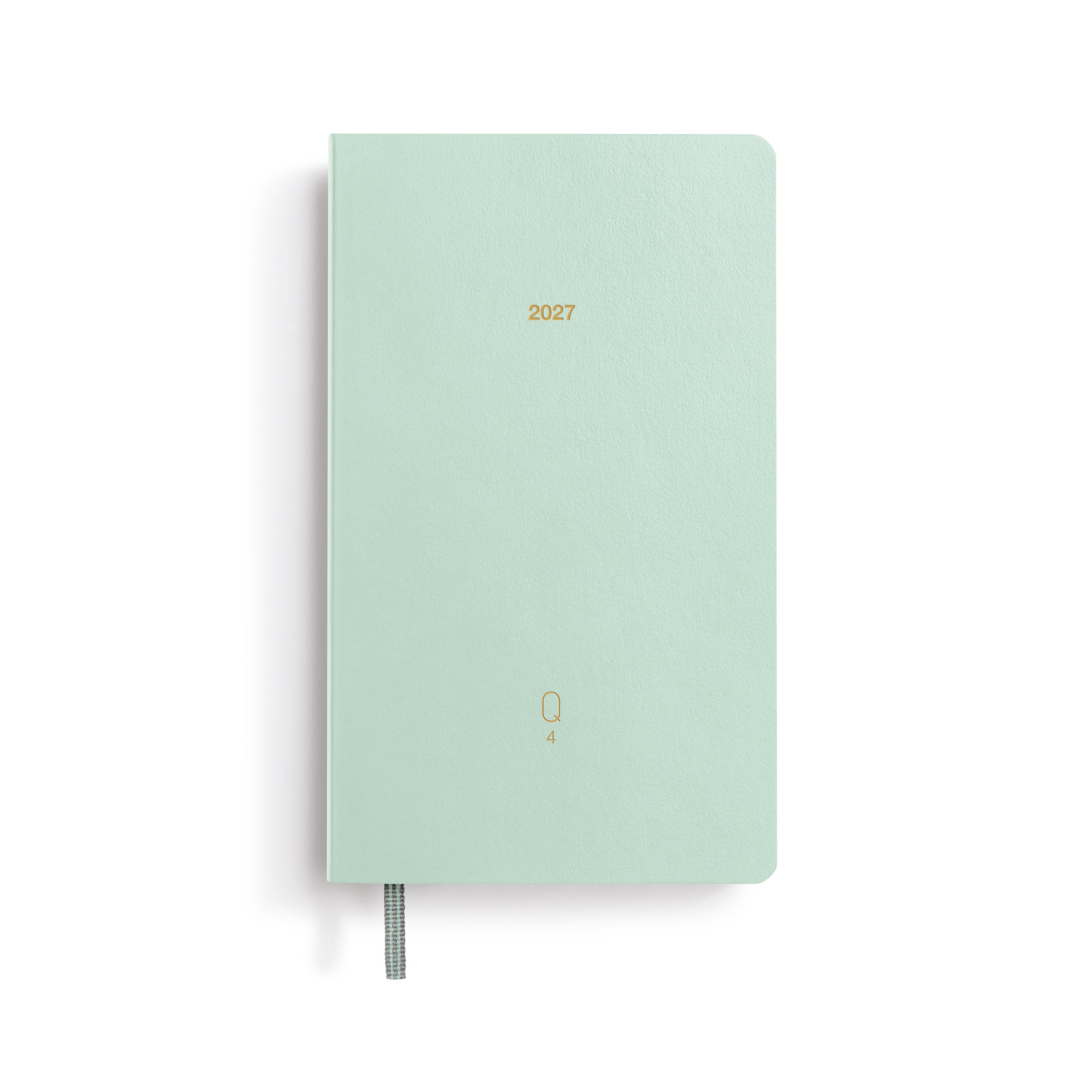 Mint green notebook with '2027' printed on a white background