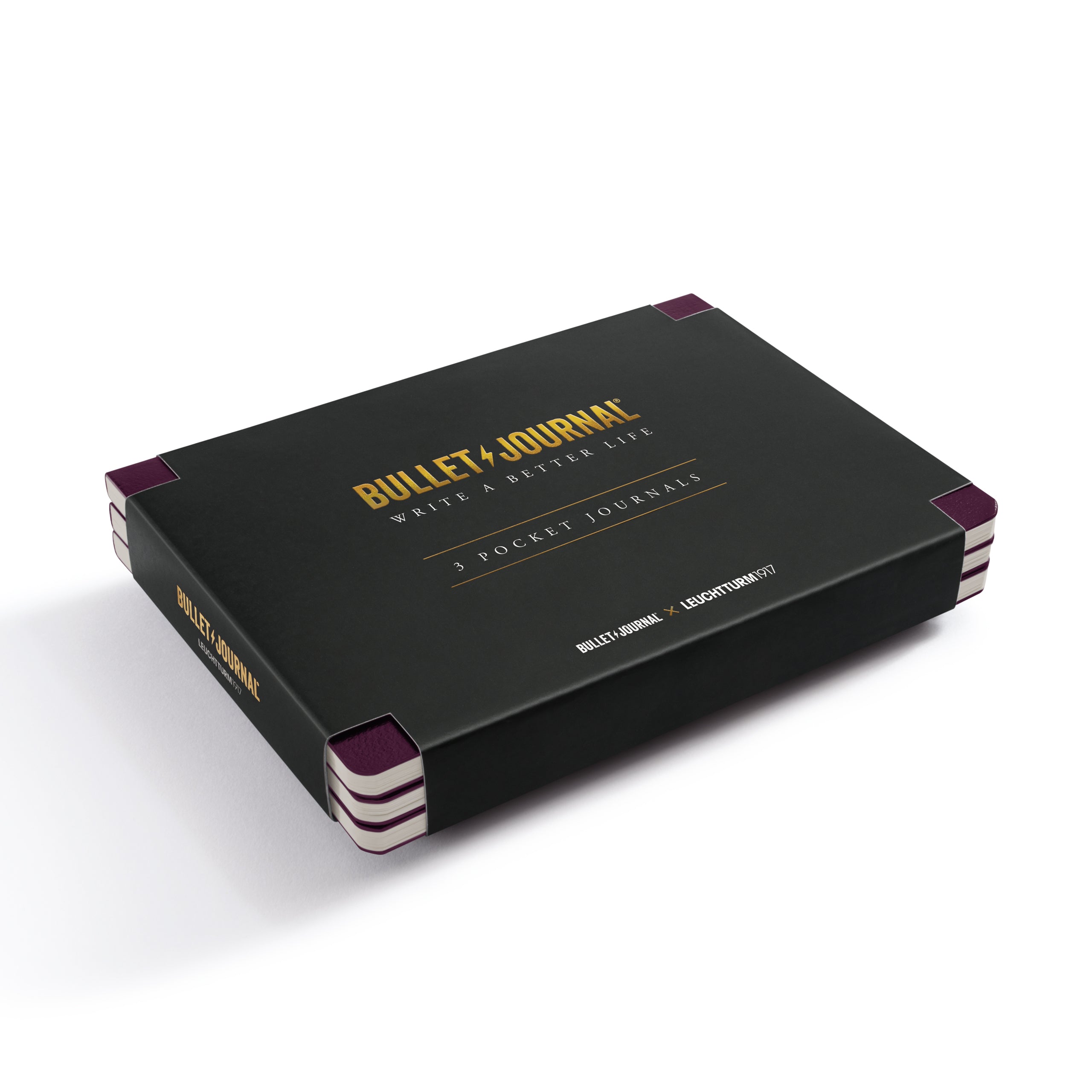 Bullet Journal 3 Pocket 100 Pages notebook set in a sleek black box with gold lettering and purple corner accents, photographed on a clean white background.