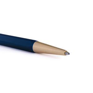 Close-up of a pen tip showing a dark navy blue barrel and a brushed gold metal tip on a white background.
