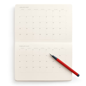 Calendar notebook with a red pen on a white background